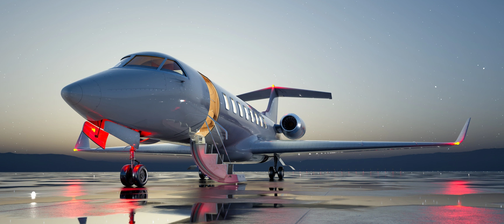 Private jet parked on an airport ramp at twilight with the cabin door open and lights reflecting across wet pavement, representing the flexibility and efficiency of fractional aircraft ownership.