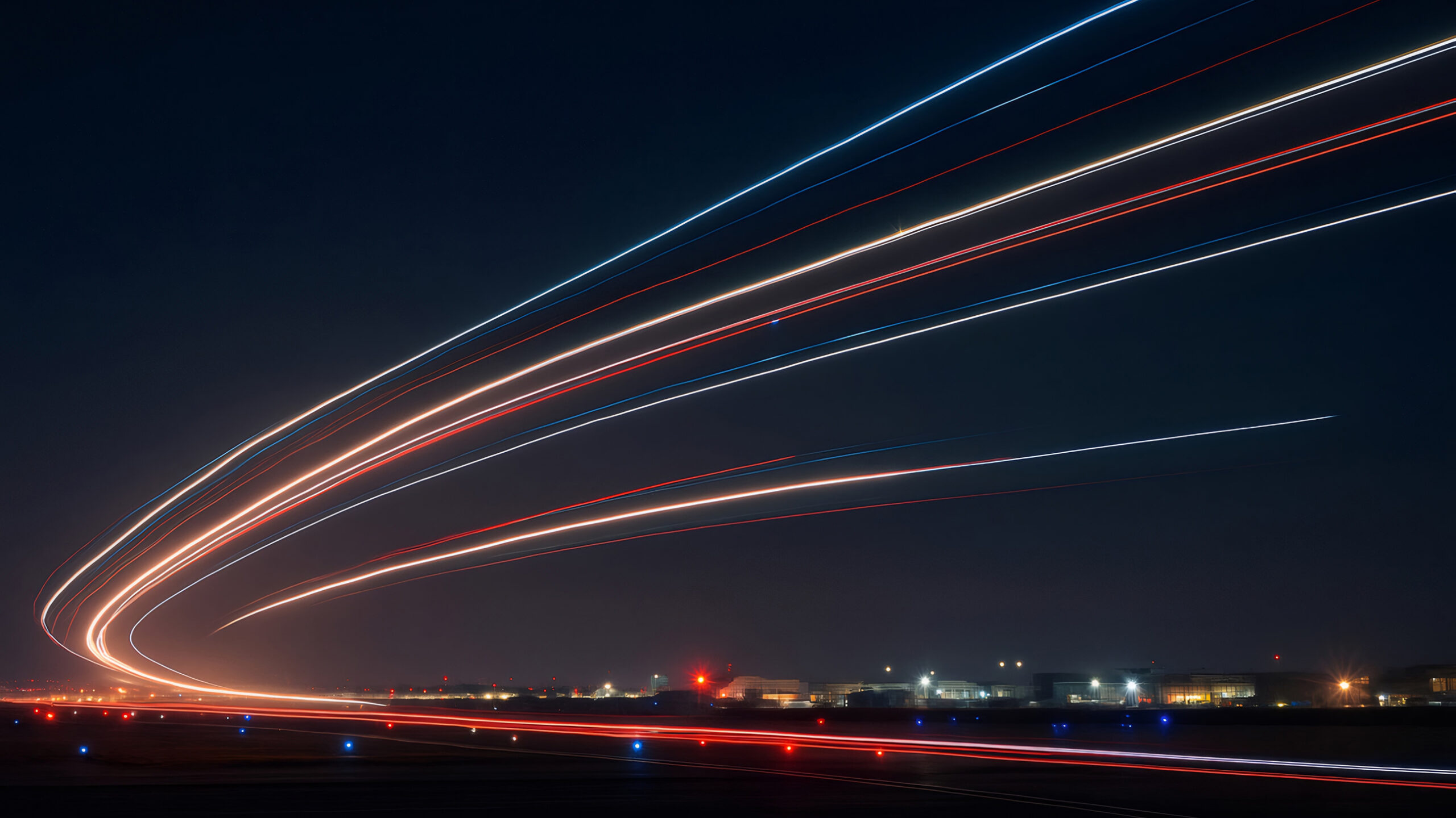 Long-exposure light trails from a departing private aircraft at night, representing the time savings, momentum, and operational freedom created by the right aircraft acquisition.