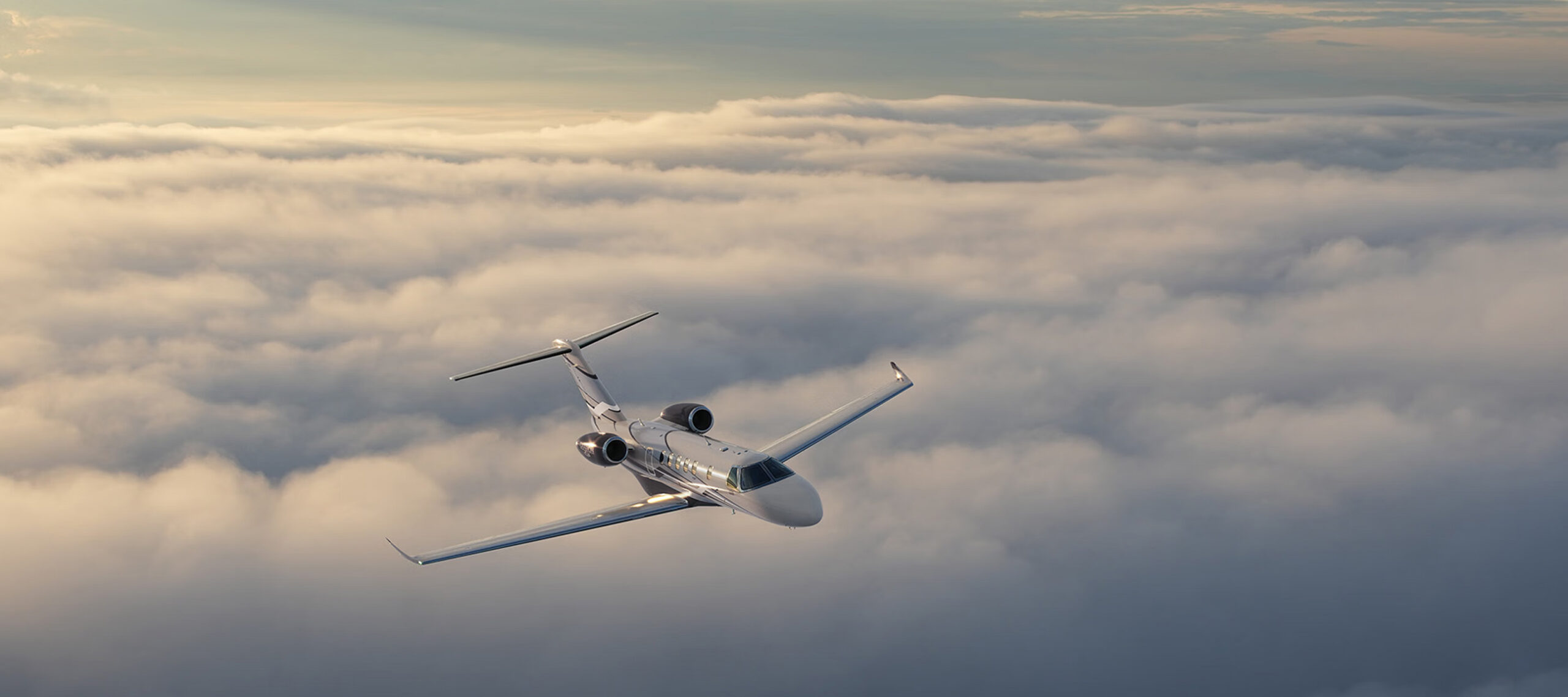 Private jet flying above the clouds at sunrise, reflecting proactive aircraft management, operational readiness, and trusted management by FLYUSA.