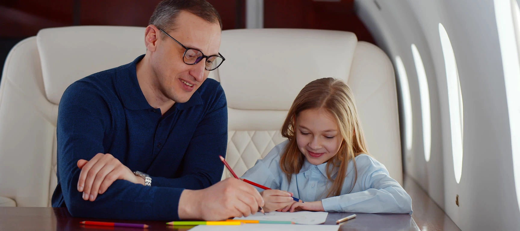 Parent and child spending quality time together inside a private jet cabin, representing the family time, travel convenience, and personalized experience of a private jet charter membership for frequent travelers.